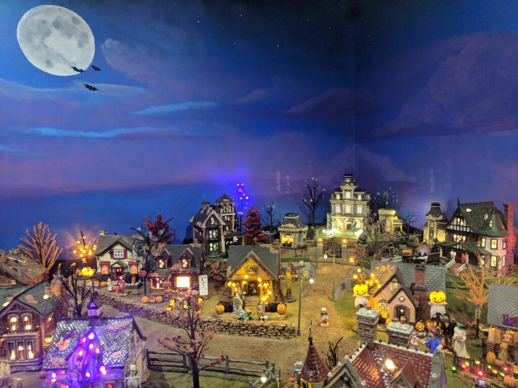 Halloween miniature layout in front of mural.