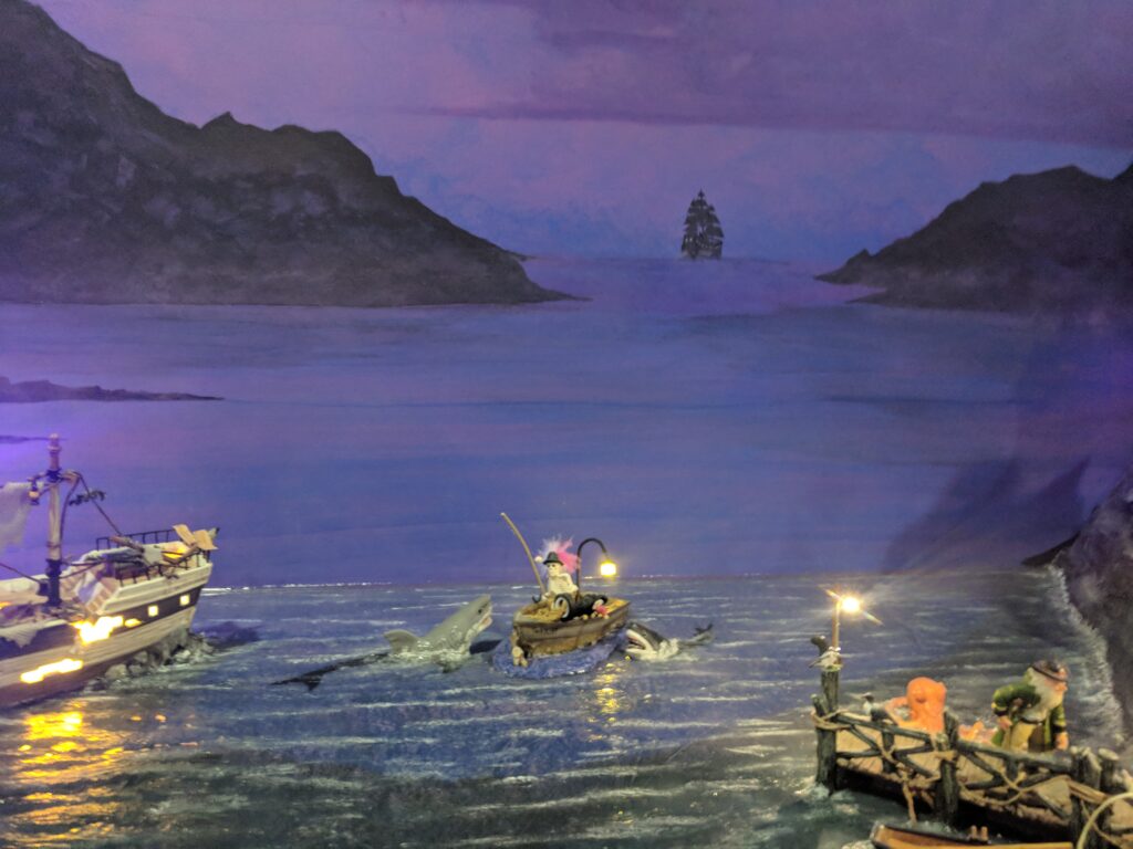 Halloween miniature layout in front of mural detail.