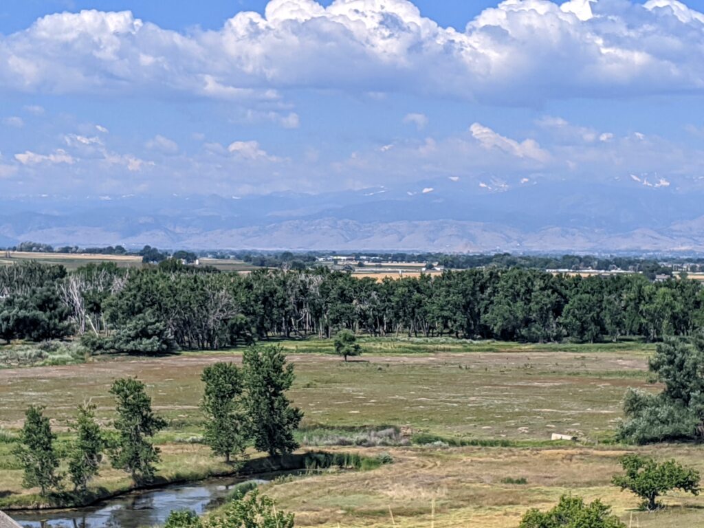 View of the Rockies and the St. Vrain river from Sandstone Ranch in Longmont, CO.