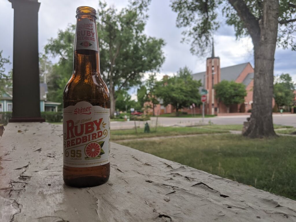 Enjoying a Shiner Ruby Redbird on the porch.