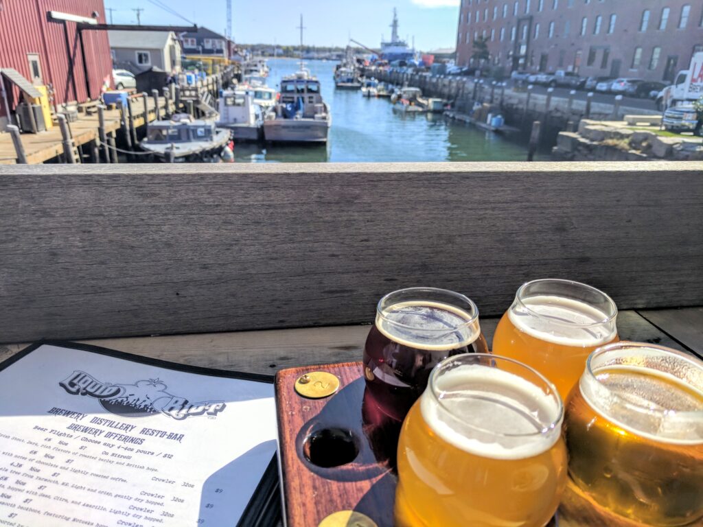 Watching the boats on the back patio at Liquid Riot Brewery & Distillery in Portland, Maine.