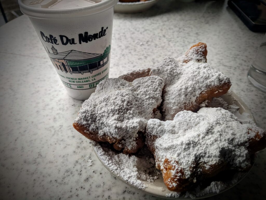 Eating beignets at Cafe du Monde while visiting New Orleans.