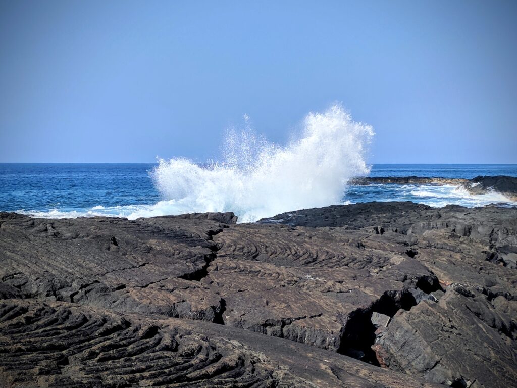 Waves crashing against the lava flow protecting Queens Bath in Kona, Hawaii.