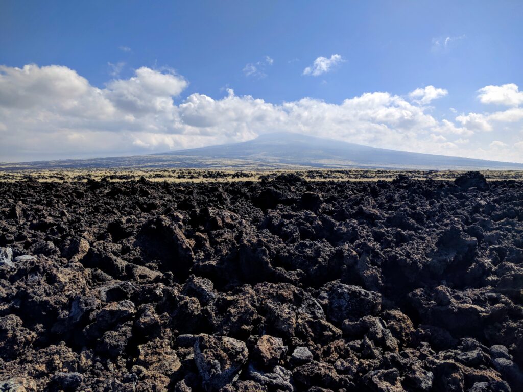 Volcano in the distance from the lava field near Makalawena Beach.